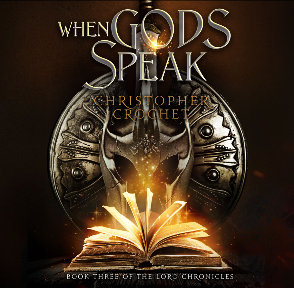 When Gods Speak book cover — a battle-worn helm and shield with a glowing open book, Book Three of The Loro Chronicles